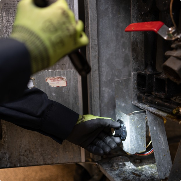 d89ce530-image-featured-desktop 1 Gloved hands of a technician working on the internal components of a commercial kitchen appliance